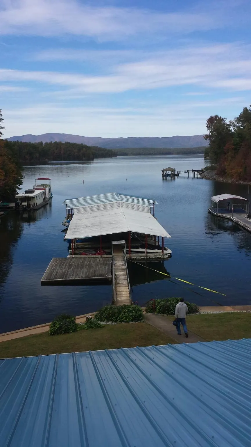 View across a lake from a newly installed blue metal roof in Hillsboro